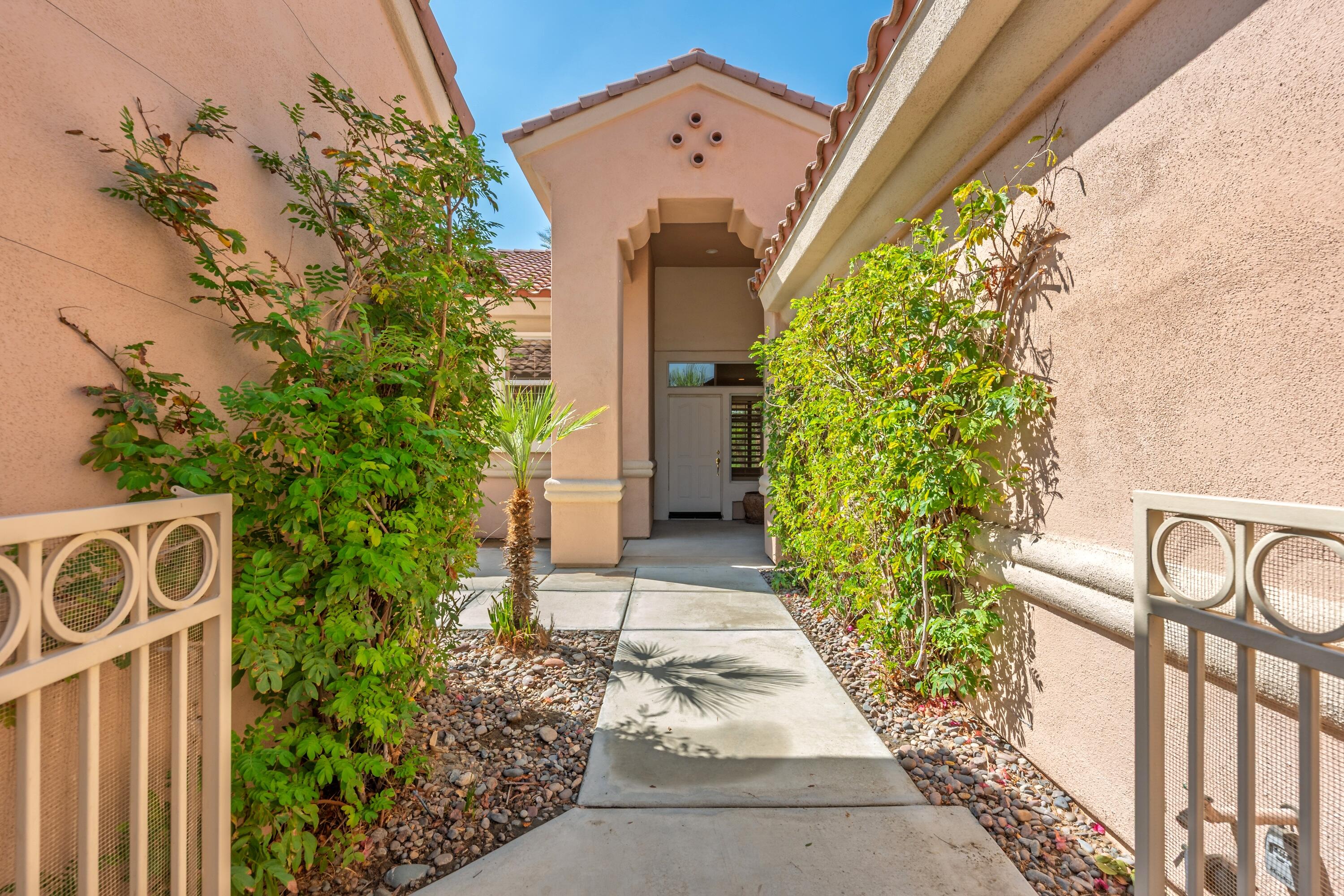 78513 Sunrise Mountain View Palm Desert, CA 92211 - Photo 8 of 45 a front view of a house with garden