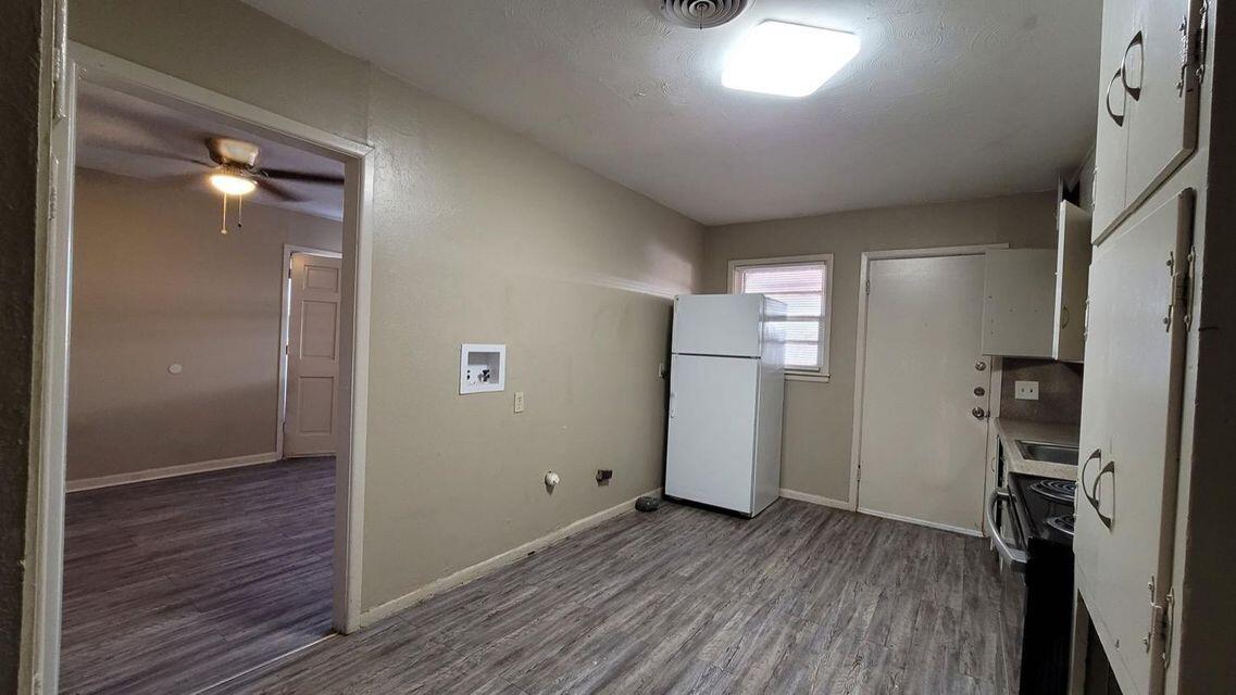 4429 31st Street Lubbock, TX 79410 - Photo 6 of 12 a view of empty room with wooden floor and windows
