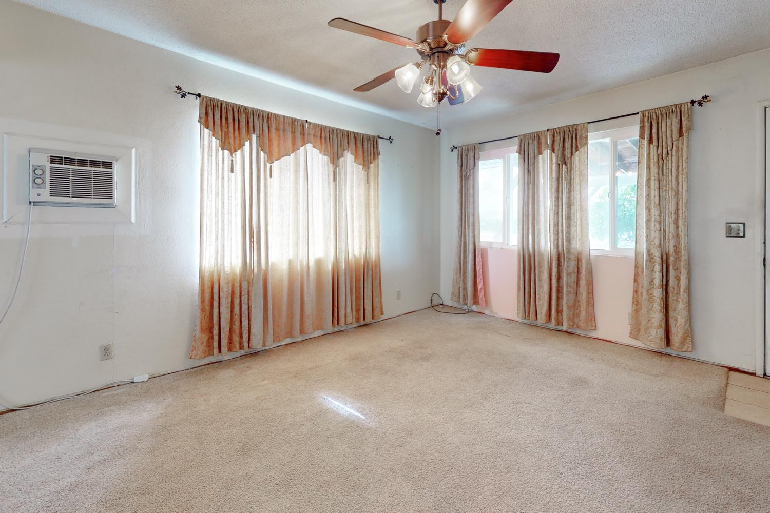2065 Howlett Avenue Yuba City, CA 95993 - Photo 6 of 52 an empty room with windows and chandelier fan