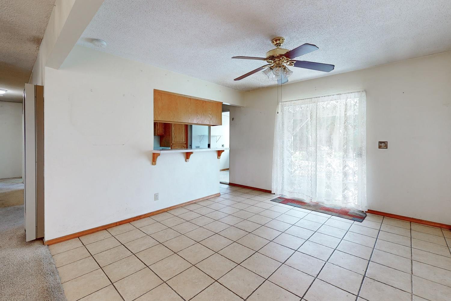 2065 Howlett Avenue Yuba City, CA 95993 - Photo 7 of 52 a view of a livingroom with a ceiling fan and window