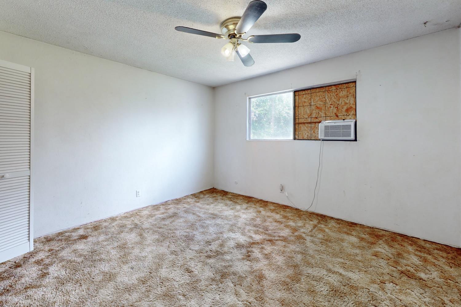 2065 Howlett Avenue Yuba City, CA 95993 - Photo 10 of 52 an empty room with windows and fan