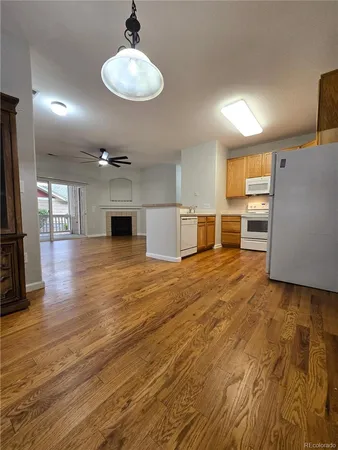 a view of a kitchen with a sink and a refrigerator