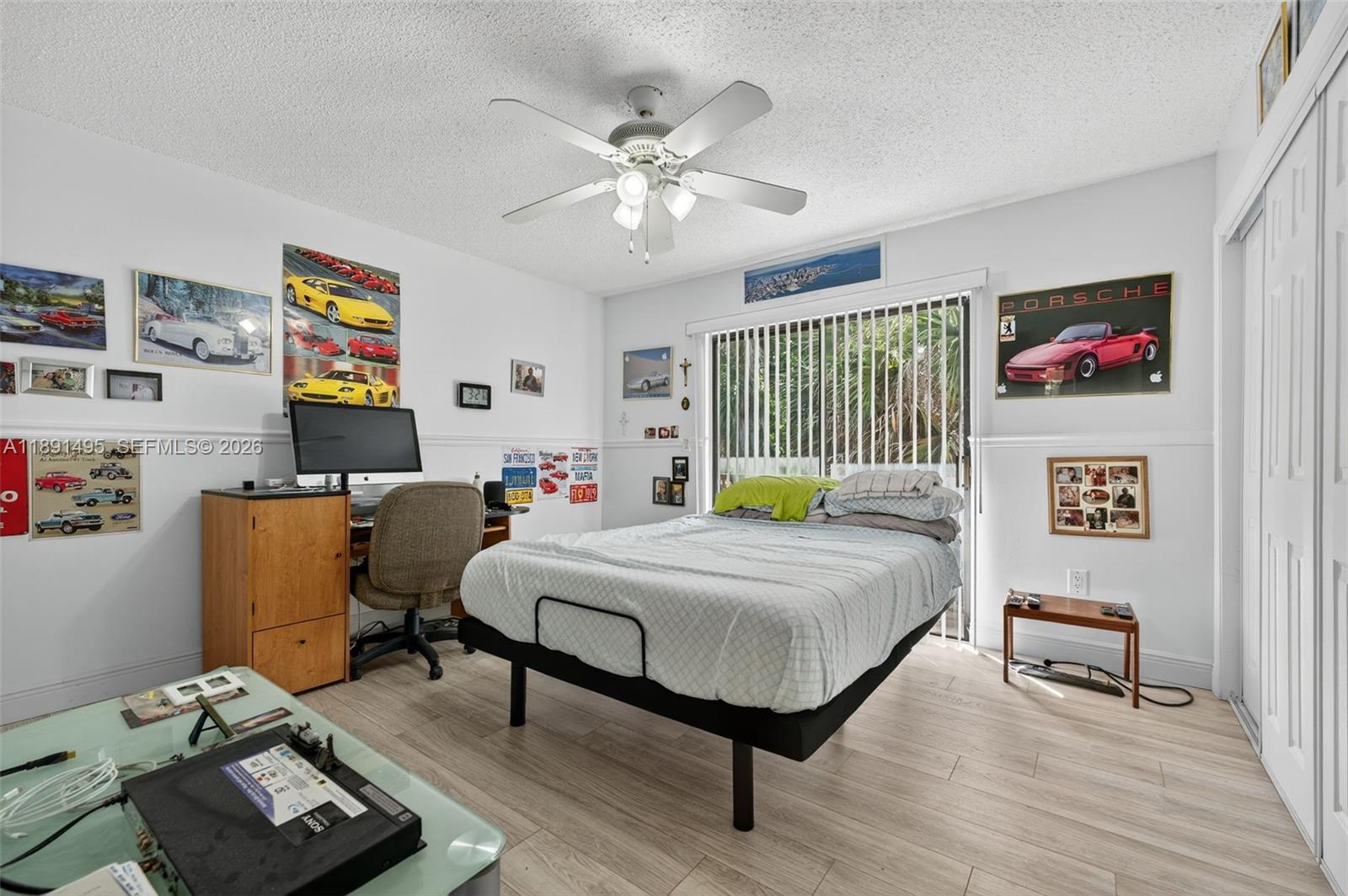 8958 West Sample Road, Unit 8958 Coral Springs, FL 33065 - Photo 14 of 37 a bedroom with a bed and a chandelier