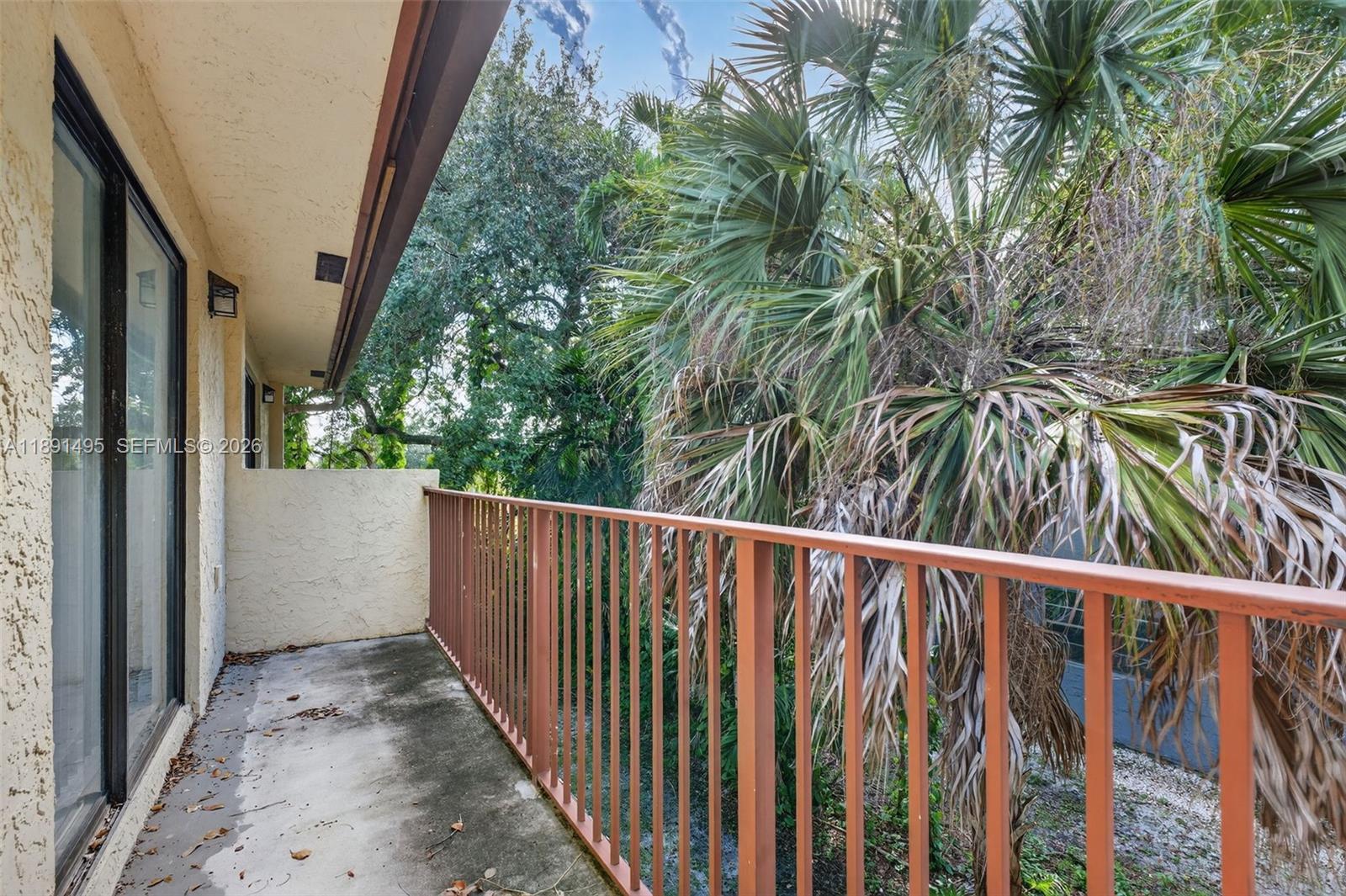 8958 West Sample Road, Unit 8958 Coral Springs, FL 33065 - Photo 18 of 37 a view of a balcony with wooden floor
