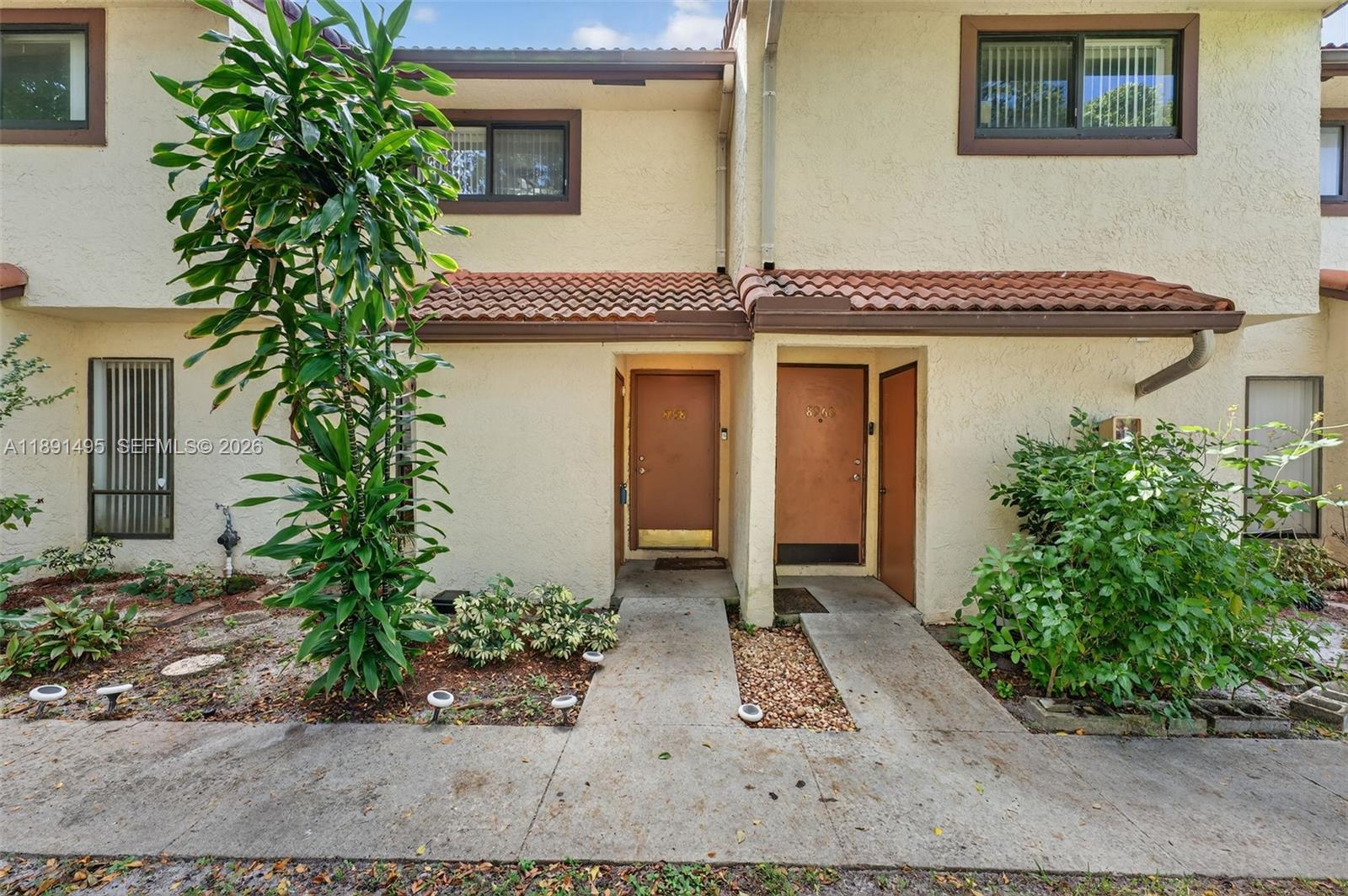 8958 West Sample Road, Unit 8958 Coral Springs, FL 33065 - Photo 23 of 37 front view of a house with a yard