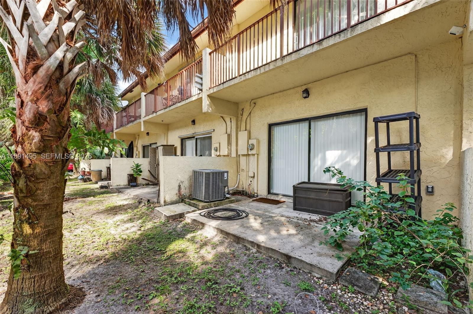8958 West Sample Road, Unit 8958 Coral Springs, FL 33065 - Photo 24 of 37 a view of a house with backyard and sitting area