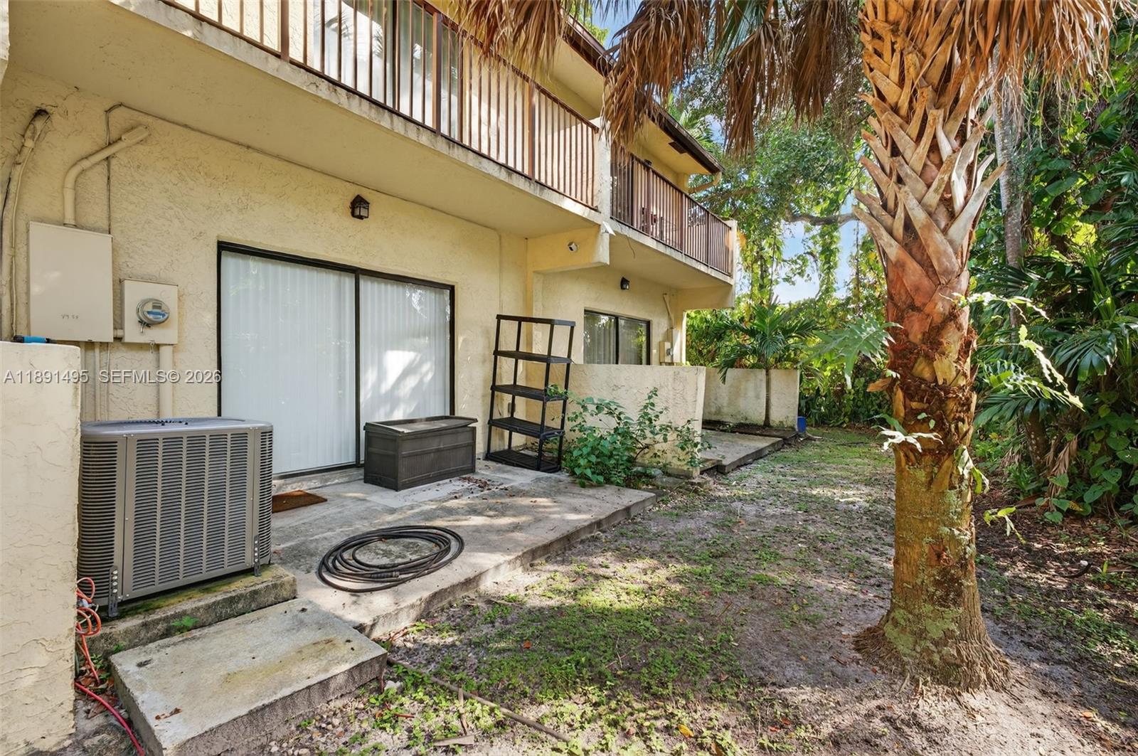 8958 West Sample Road, Unit 8958 Coral Springs, FL 33065 - Photo 25 of 37 a backyard of a house with yard and outdoor seating