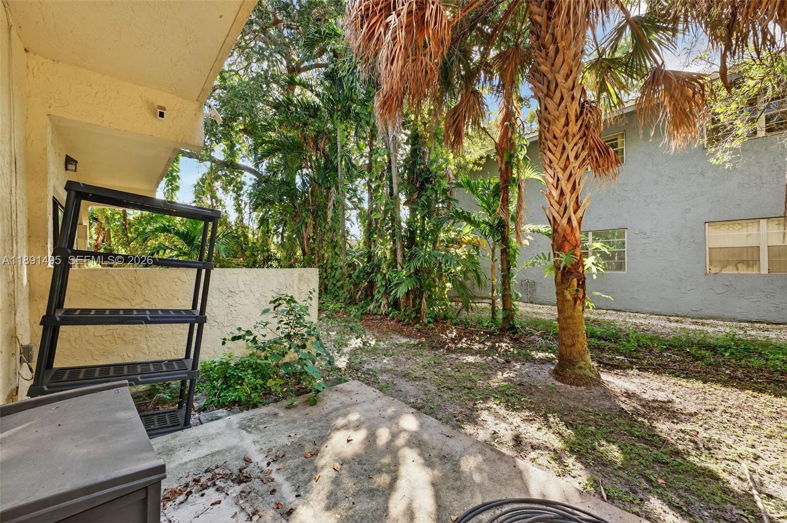 8958 West Sample Road, Unit 8958 Coral Springs, FL 33065 - Photo 26 of 37 a backyard of a house with lots of green space