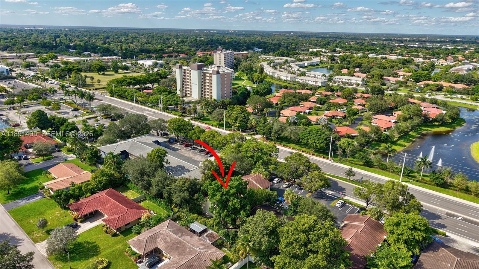 8958 West Sample Road, Unit 8958 Coral Springs, FL 33065 - Photo 29 of 37 an aerial view of residential houses with outdoor space and trees