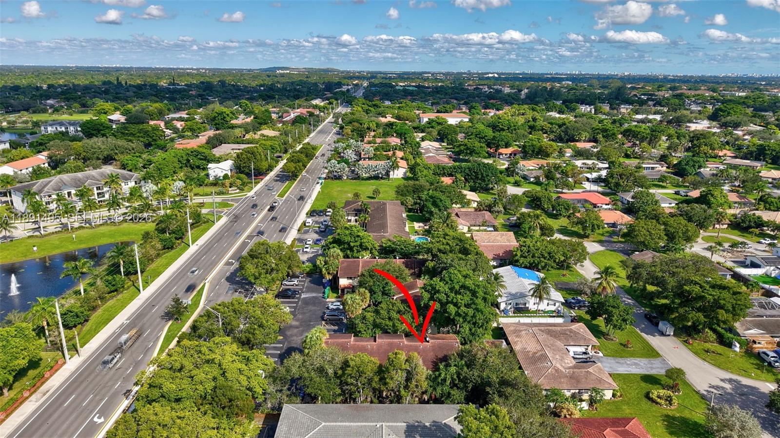 8958 West Sample Road, Unit 8958 Coral Springs, FL 33065 - Photo 33 of 37 an aerial view of residential houses with outdoor space and trees