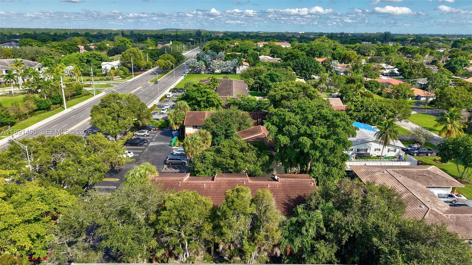 8958 West Sample Road, Unit 8958 Coral Springs, FL 33065 - Photo 36 of 37 an aerial view of a house with a yard and lake view