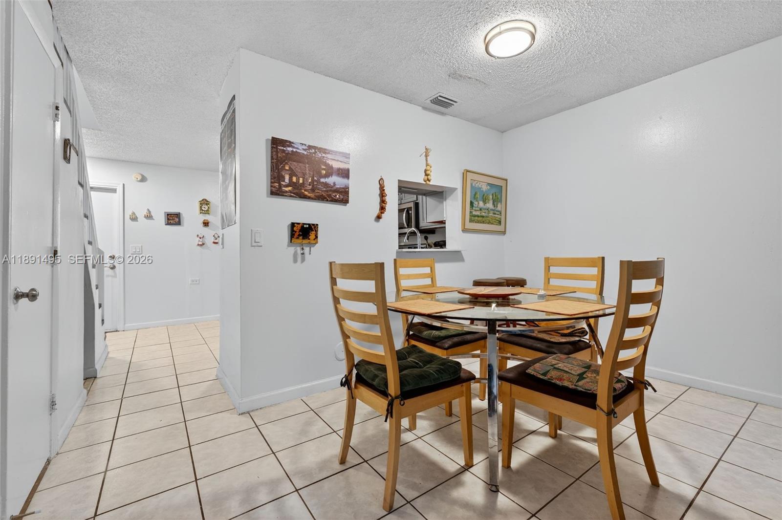 8958 West Sample Road, Unit 8958 Coral Springs, FL 33065 - Photo 5 of 37 a view of a dining room with furniture and a chandelier