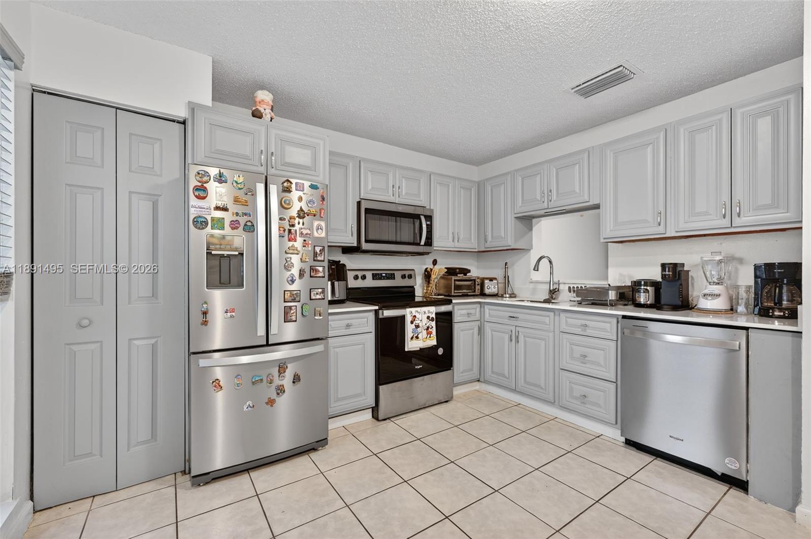 8958 West Sample Road, Unit 8958 Coral Springs, FL 33065 - Photo 10 of 37 a kitchen with granite countertop cabinets and steel stainless steel appliances