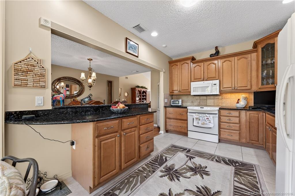 12415 Harbour Ridge Boulevard, Unit 48 Palm City, FL 34990 - Photo 14 of 34 a large kitchen with stainless steel appliances a stove a sink and a refrigerator