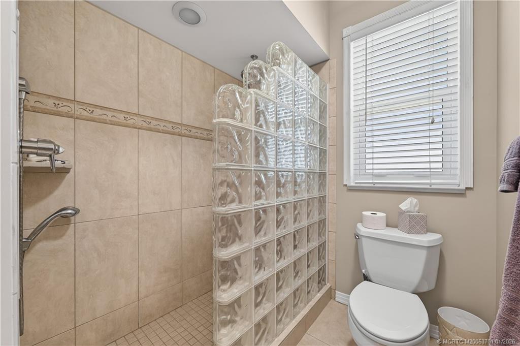 12415 Harbour Ridge Boulevard, Unit 48 Palm City, FL 34990 - Photo 19 of 34 a bathroom with a toilet a sink and a shower