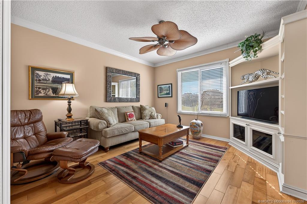 12415 Harbour Ridge Boulevard, Unit 48 Palm City, FL 34990 - Photo 20 of 34 a living room with furniture a flat screen tv and a window