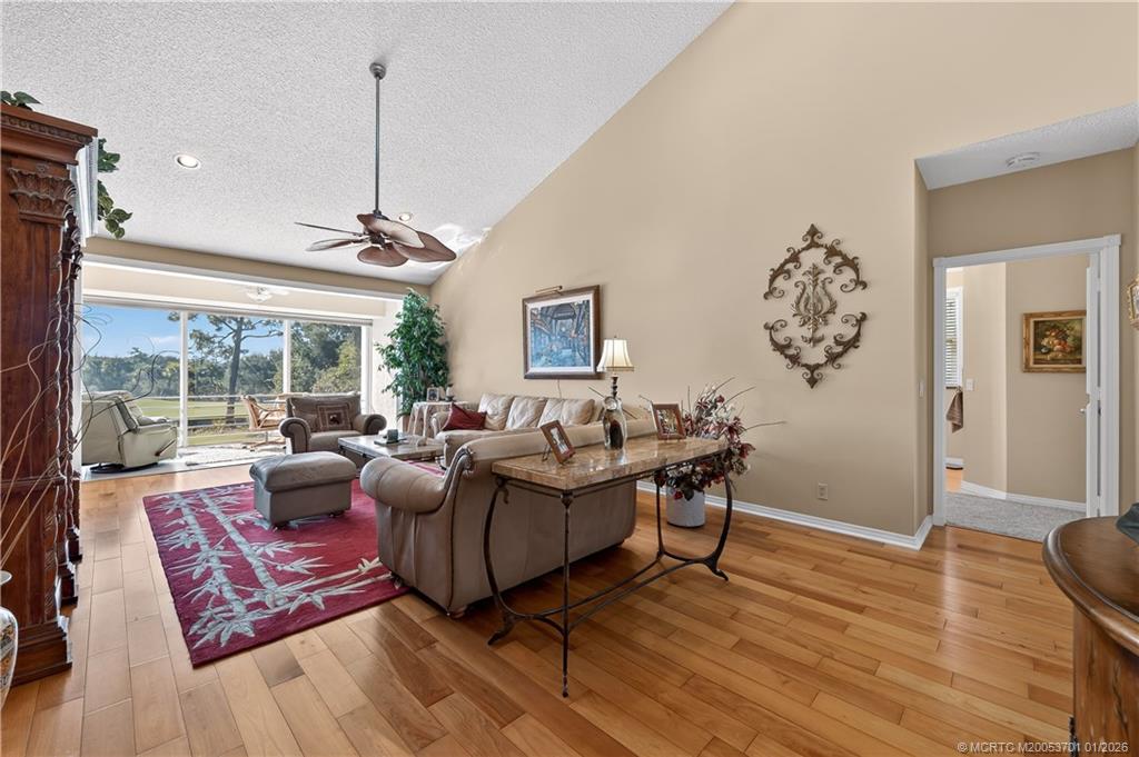 12415 Harbour Ridge Boulevard, Unit 48 Palm City, FL 34990 - Photo 2 of 34 a living room with furniture and wooden floor