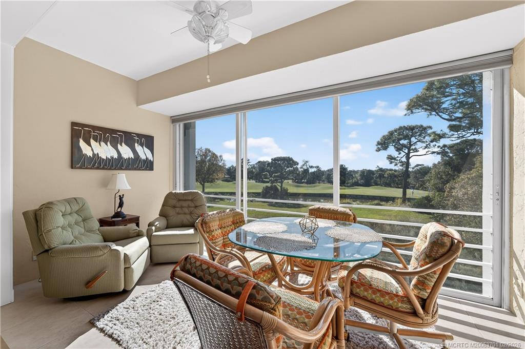 12415 Harbour Ridge Boulevard, Unit 48 Palm City, FL 34990 - Photo 2 of 34 a outdoor living space with patio furniture and a floor to ceiling window