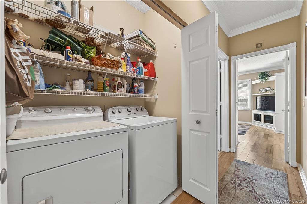 12415 Harbour Ridge Boulevard, Unit 48 Palm City, FL 34990 - Photo 24 of 34 a view of storage and utility room with washer and dryer