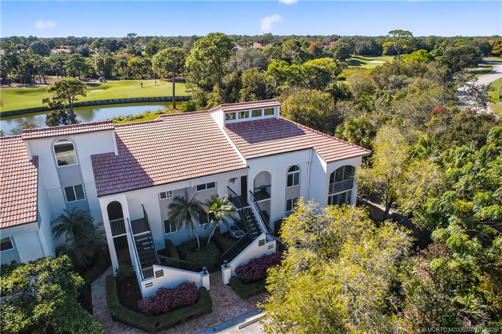 12415 Harbour Ridge Boulevard, Unit 48 Palm City, FL 34990 - Photo 26 of 34 a view of a house with a yard and sitting area