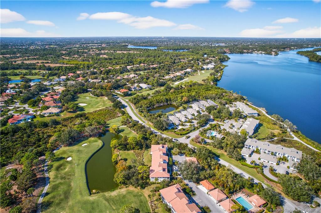12415 Harbour Ridge Boulevard, Unit 48 Palm City, FL 34990 - Photo 33 of 34 an aerial view of a houses with a lake view