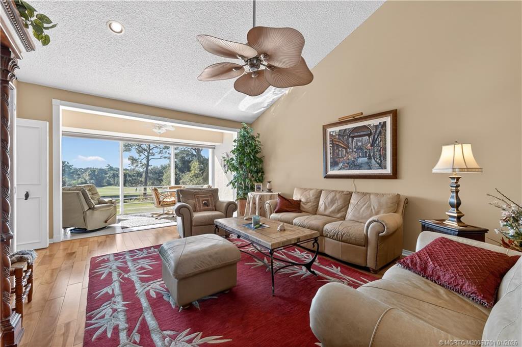 12415 Harbour Ridge Boulevard, Unit 48 Palm City, FL 34990 - Photo 5 of 34 a living room with furniture and a large window