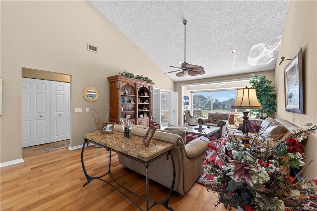 12415 Harbour Ridge Boulevard, Unit 48 Palm City, FL 34990 - Photo 5 of 34 a living room with furniture and a wooden floor