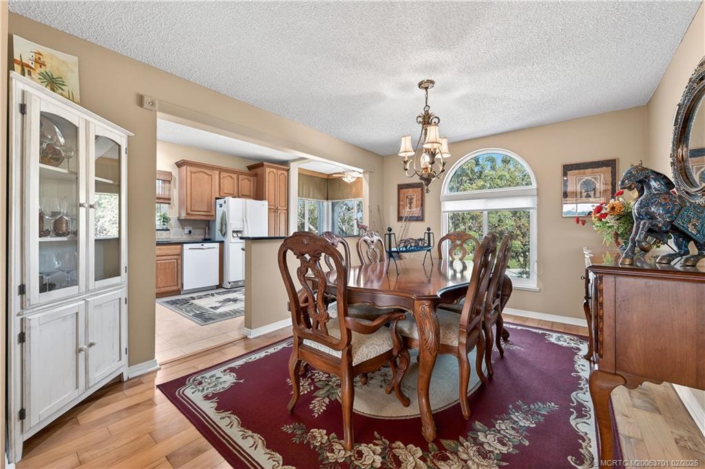 12415 Harbour Ridge Boulevard, Unit 48 Palm City, FL 34990 - Photo 9 of 34 a view of a dining room with furniture window and wooden floor