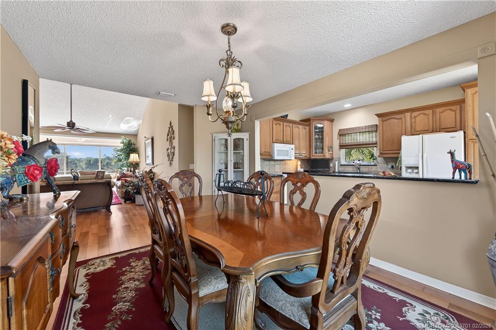 12415 Harbour Ridge Boulevard, Unit 48 Palm City, FL 34990 - Photo 10 of 34 a view of a dining room with furniture and a chandelier