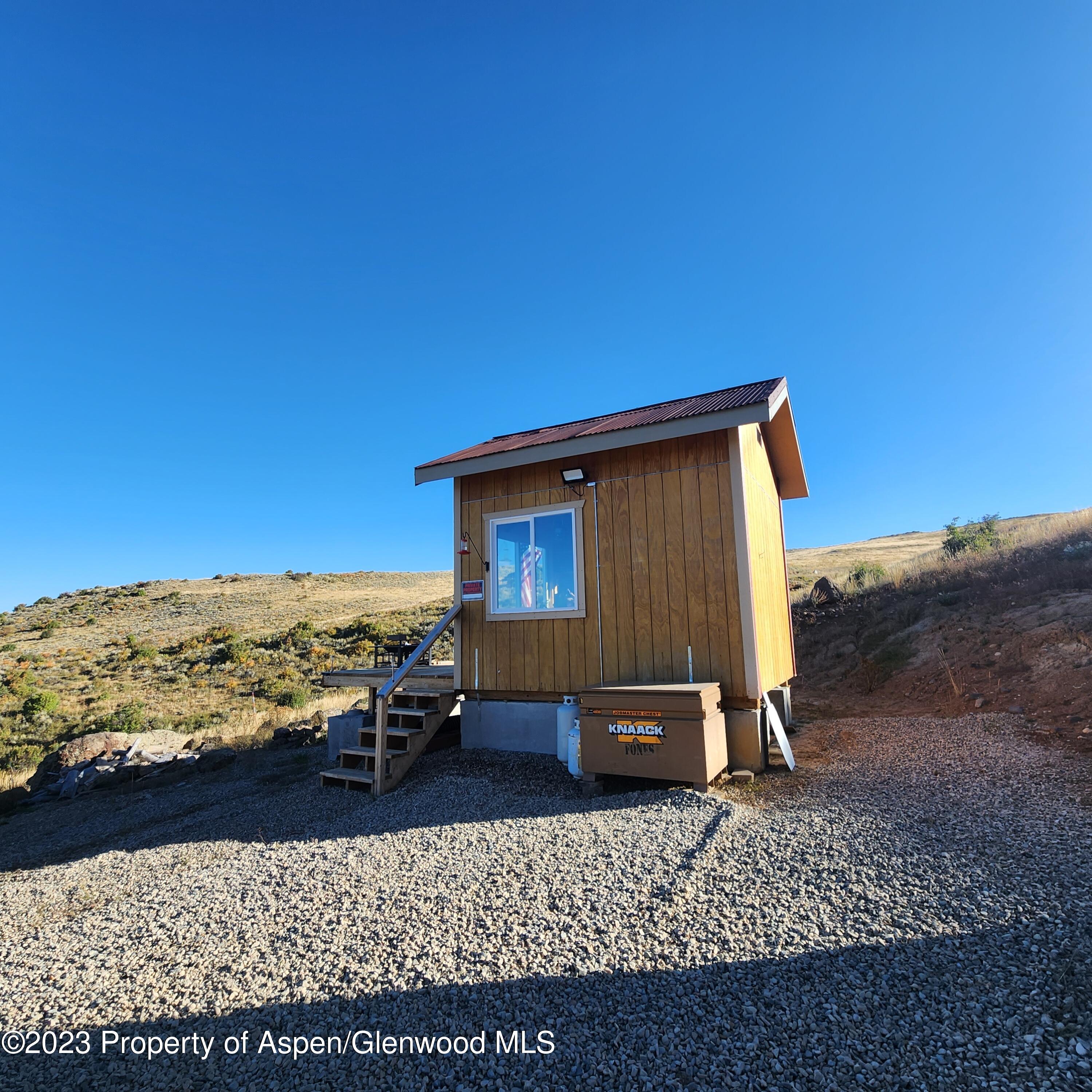 a backyard of a house with a large tree
