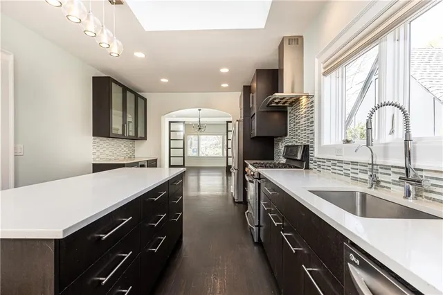 a kitchen with a sink and a large window