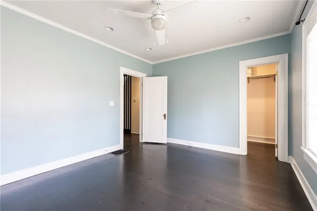 an empty room with wooden floor and door