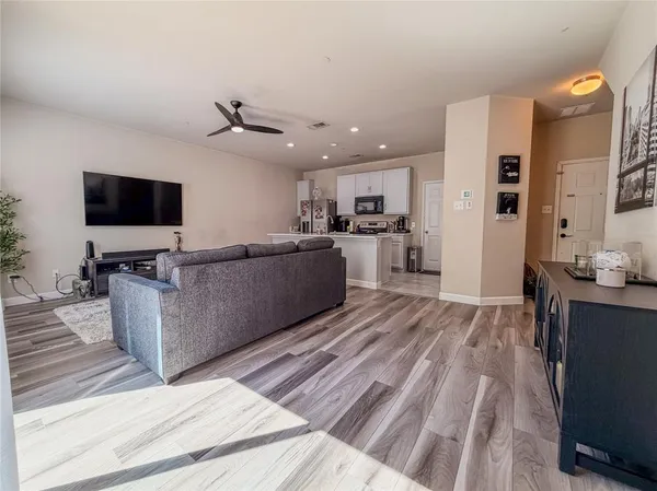 a living room with kitchen island furniture and a flat screen tv