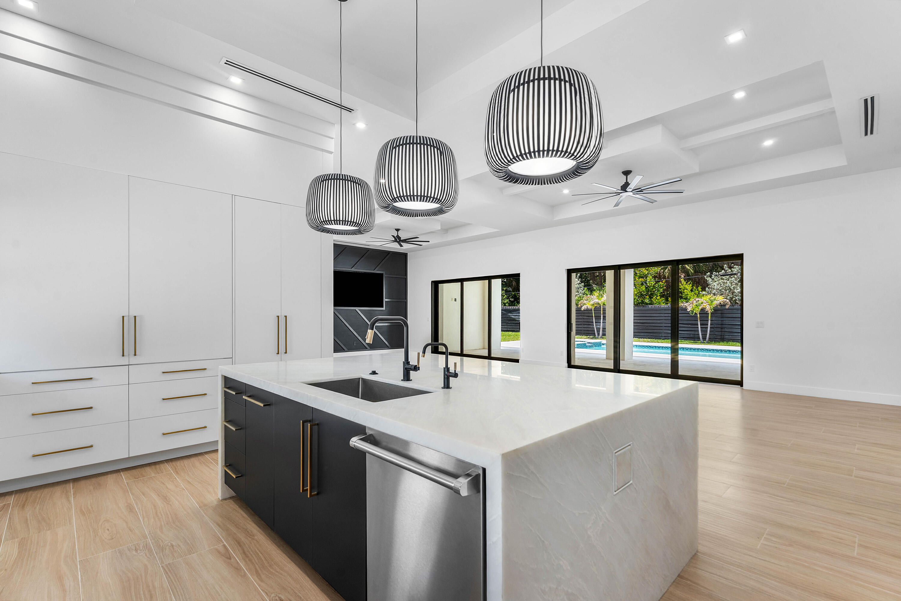 5701 Old Orange Road Jupiter, FL 33458 - Photo 5 of 46 a large kitchen with stainless steel appliances a large center island attached withe living room