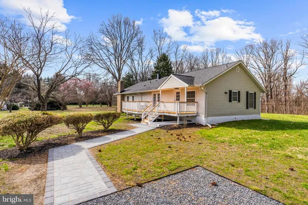 a view of a house with a yard covered with snow in front of house