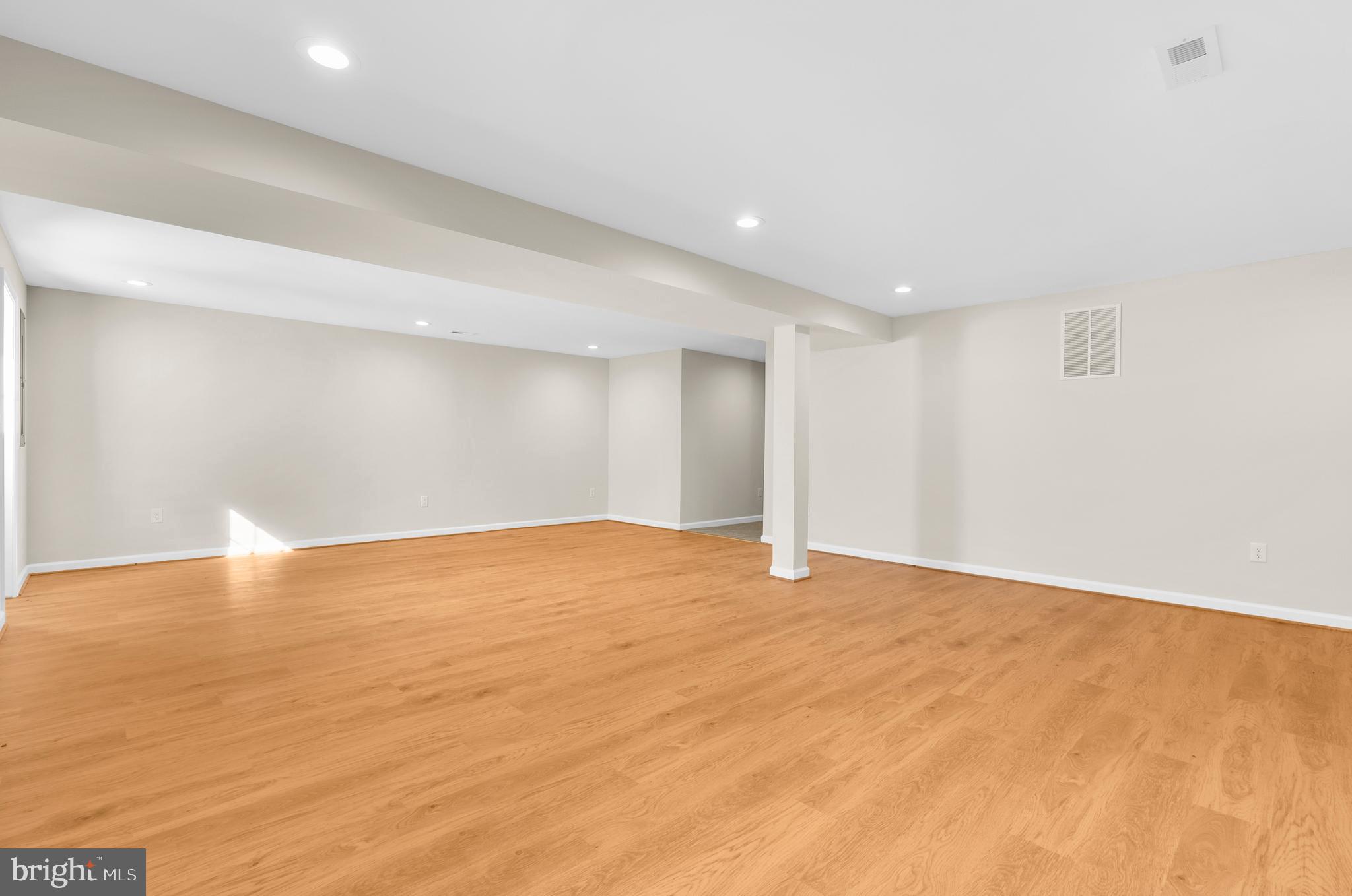 5485 Solomons Island Road Lothian, MD 20711 - Photo 22 of 64 a view of an empty room with wooden floor