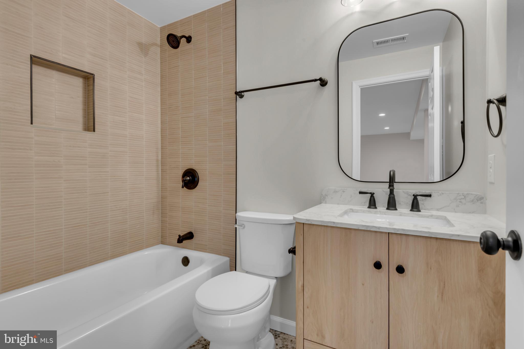 5485 Solomons Island Road Lothian, MD 20711 - Photo 32 of 64 a bathroom with a sink a toilet and a mirror