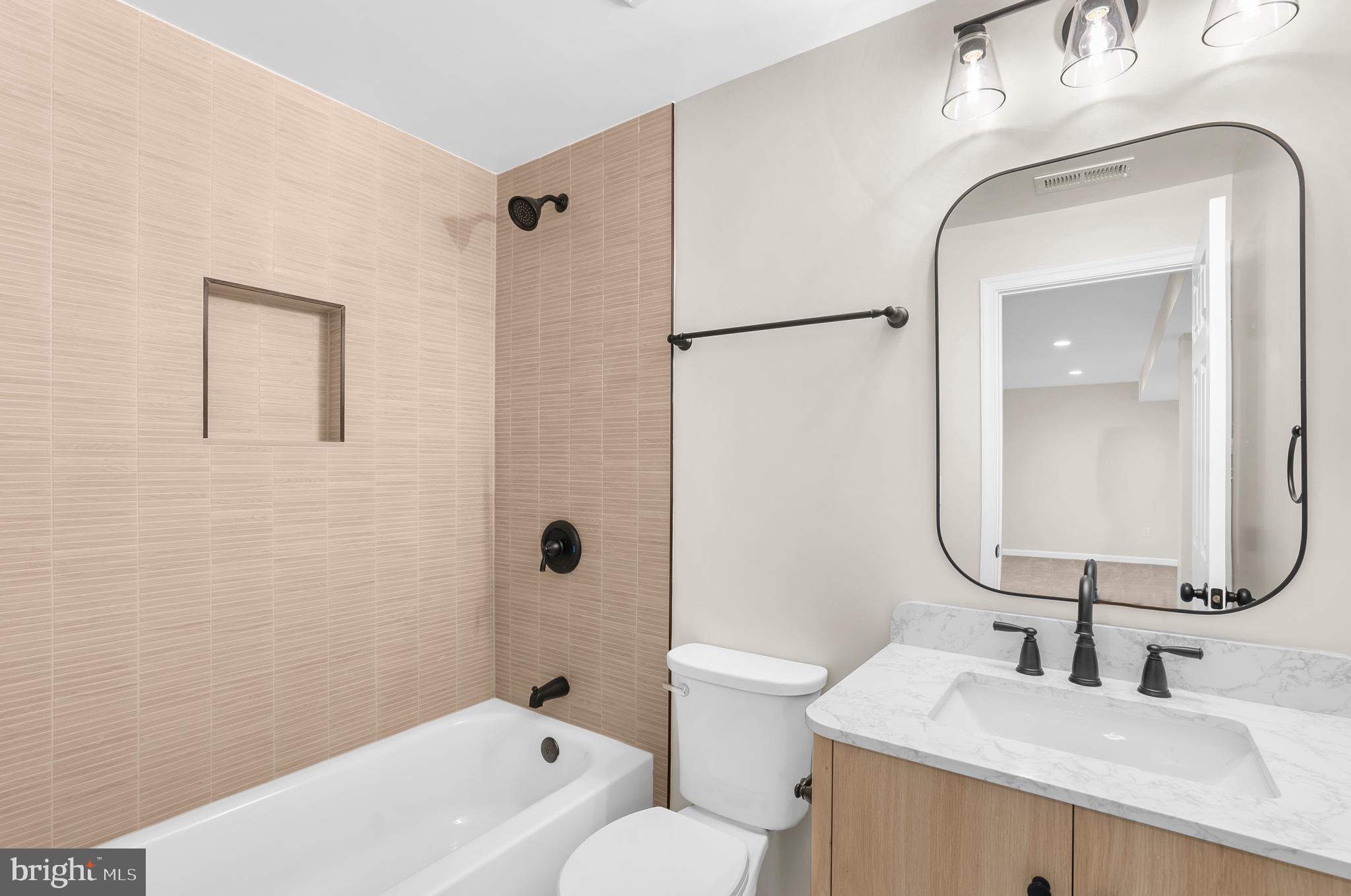 5485 Solomons Island Road Lothian, MD 20711 - Photo 33 of 64 a bathroom with a sink toilet and shower