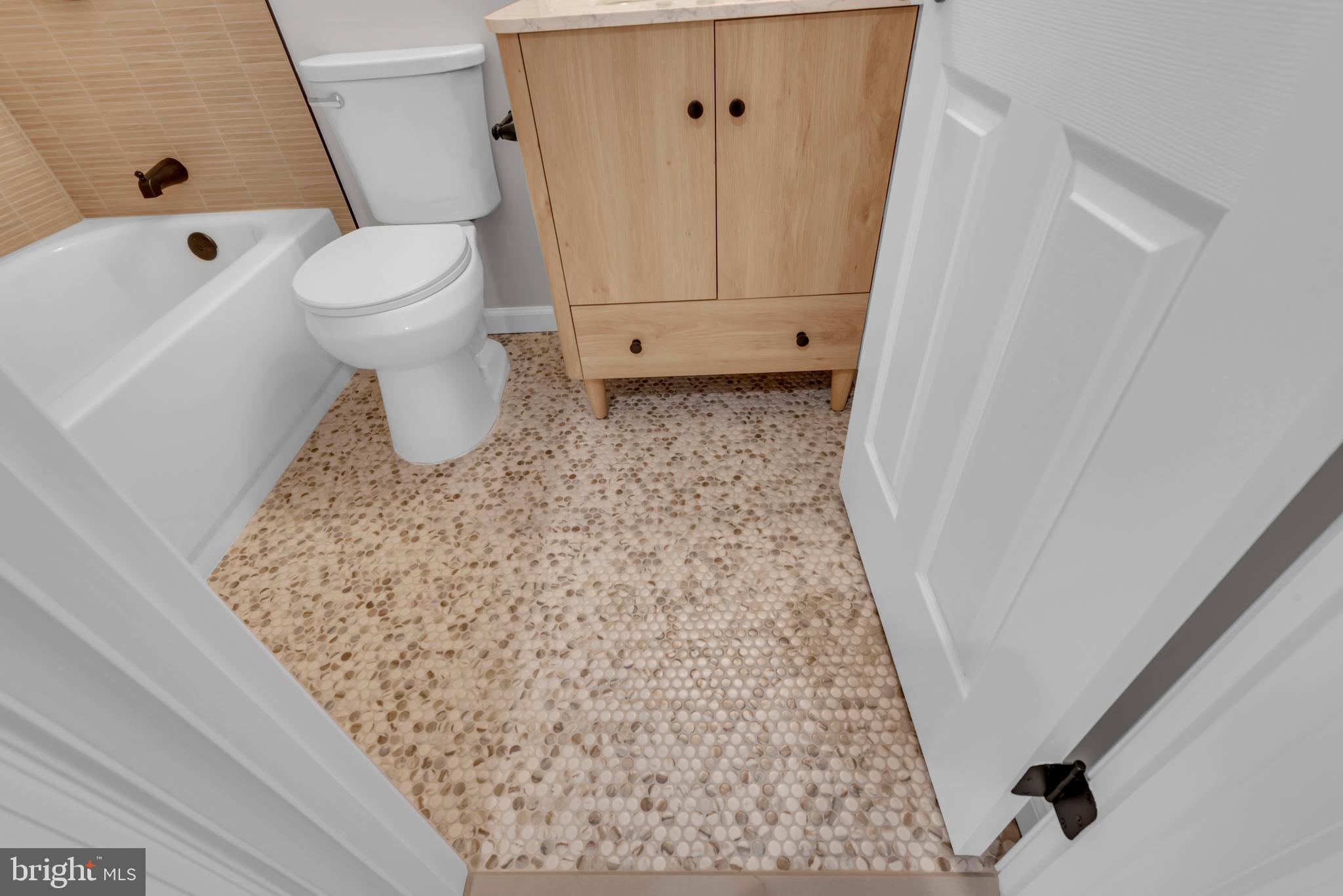 5485 Solomons Island Road Lothian, MD 20711 - Photo 34 of 64 a bathroom with a sink a toilet and shower