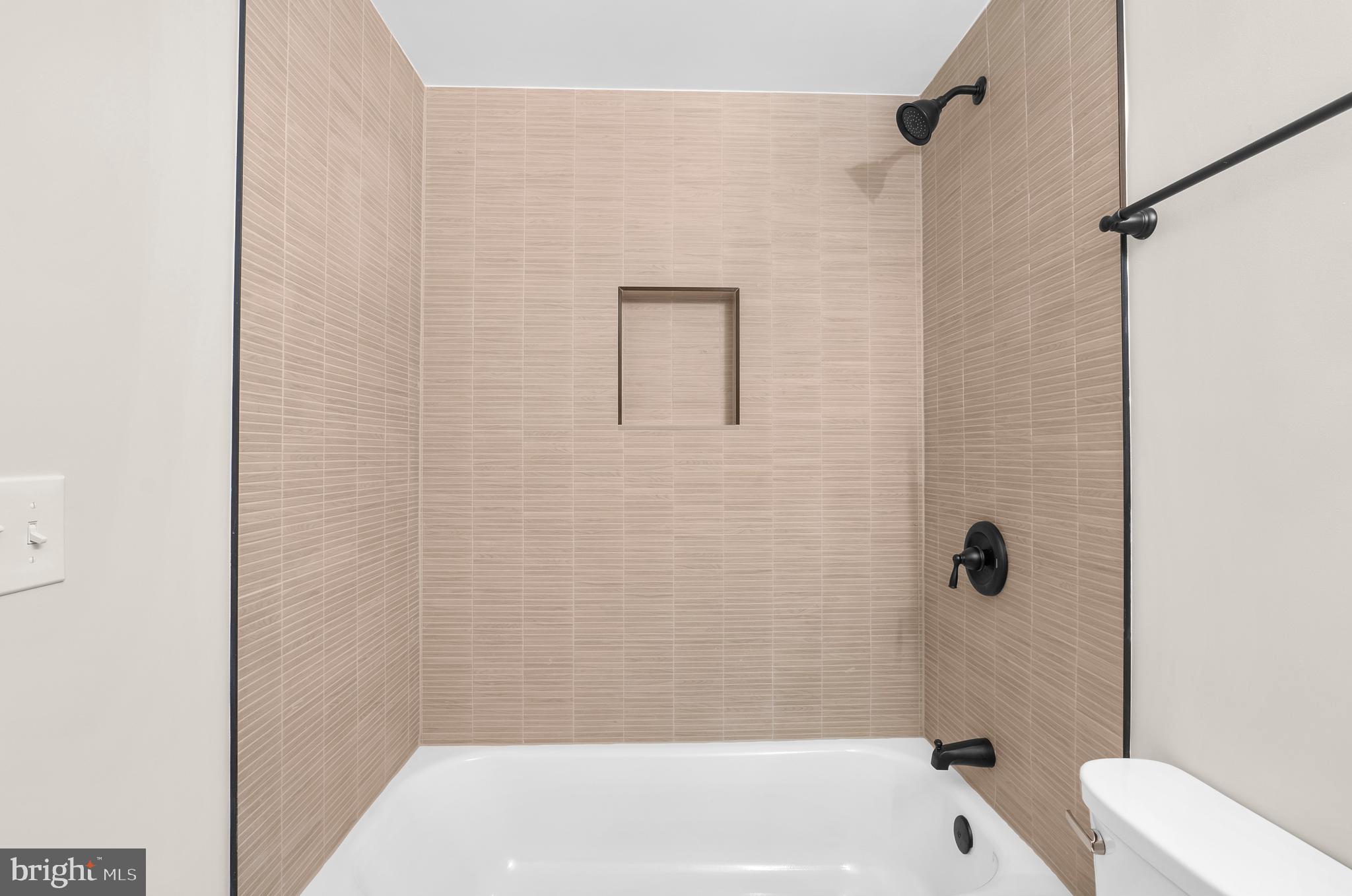 5485 Solomons Island Road Lothian, MD 20711 - Photo 35 of 64 a bathroom with a bathtub and shower