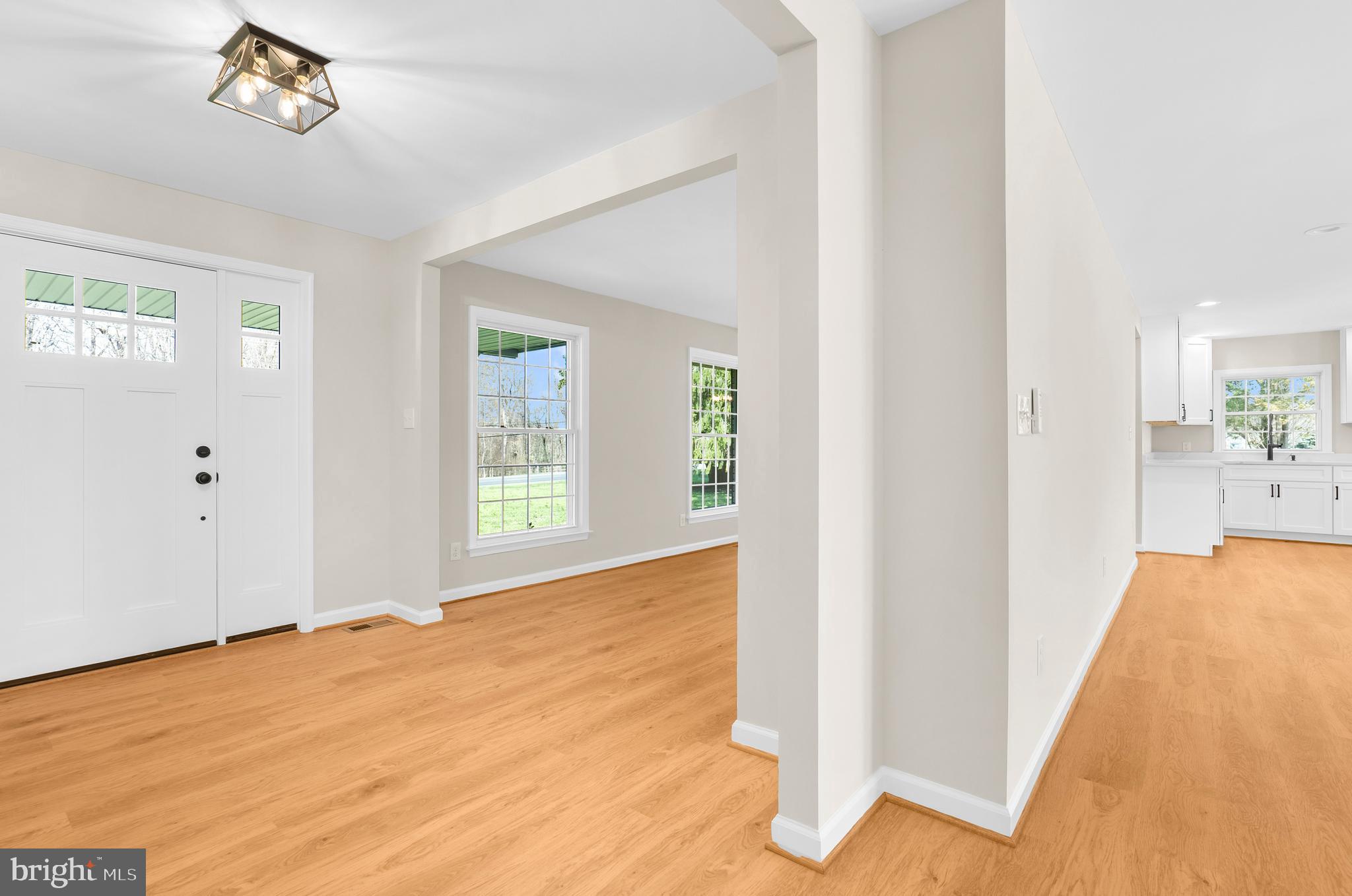 5485 Solomons Island Road Lothian, MD 20711 - Photo 41 of 64 a view of an empty room with wooden floor and a window