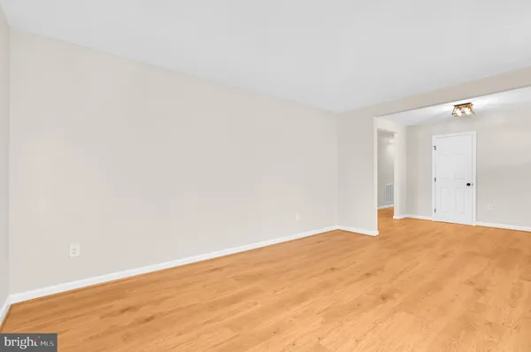 a view of an empty room with window and fireplace