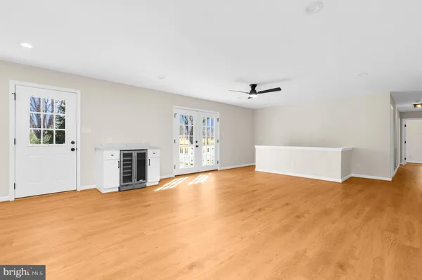 a view of a kitchen with stainless steel appliances wooden floor and a window