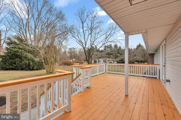 a view of balcony with wooden floor and fence