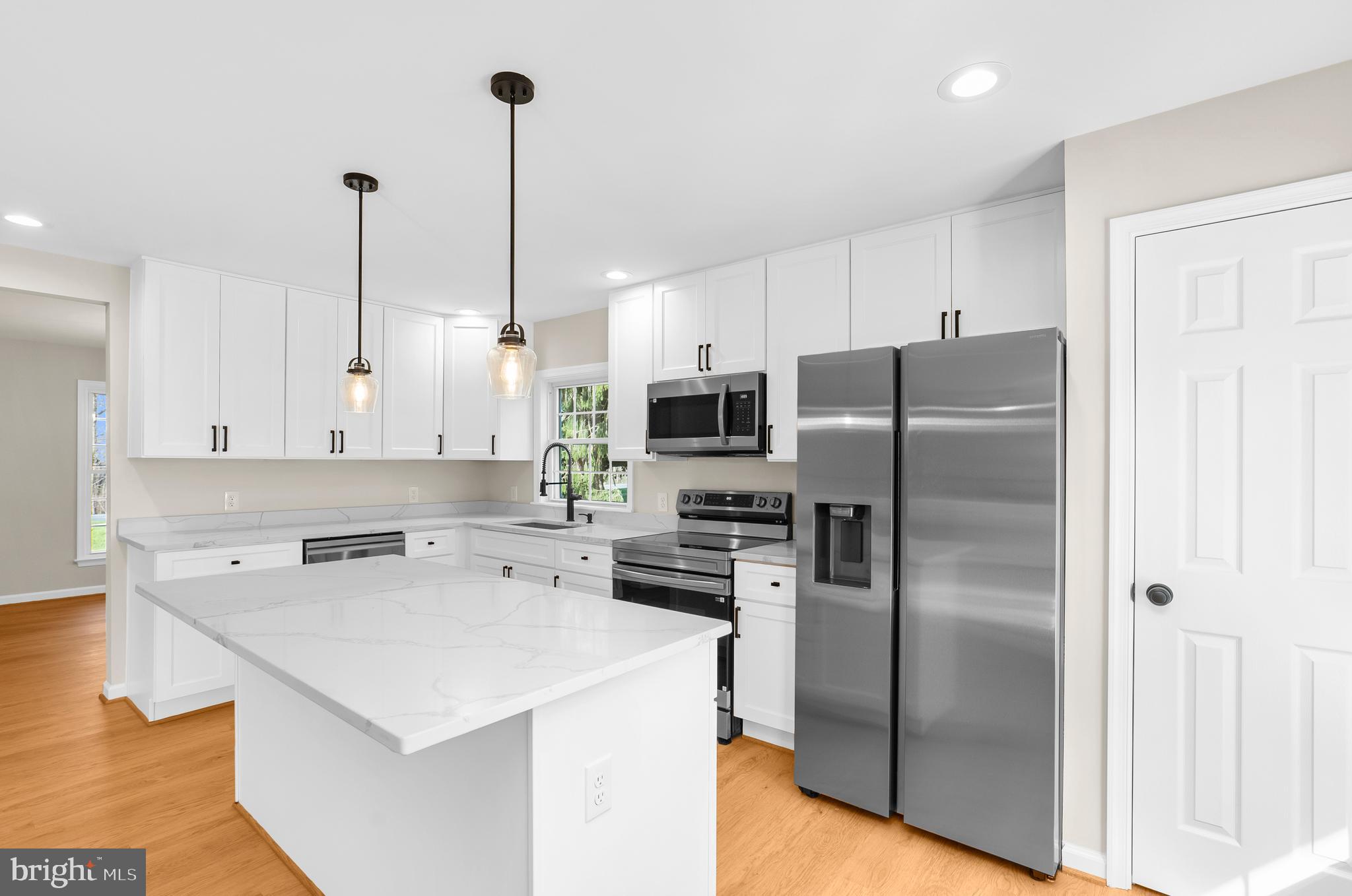 5485 Solomons Island Road Lothian, MD 20711 - Photo 51 of 64 a kitchen with stainless steel appliances a refrigerator sink and microwave