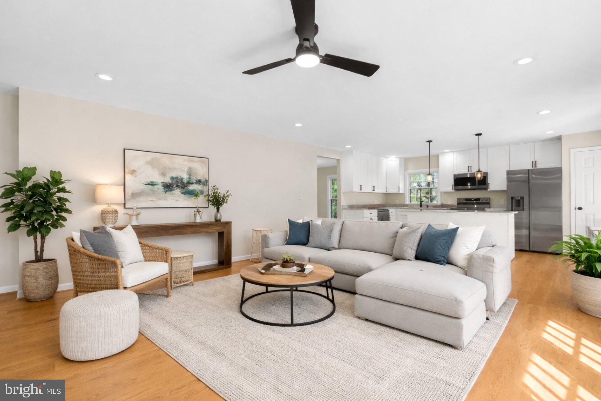 5485 Solomons Island Road Lothian, MD 20711 - Photo 52 of 64 a living room with furniture potted plant and a lamp