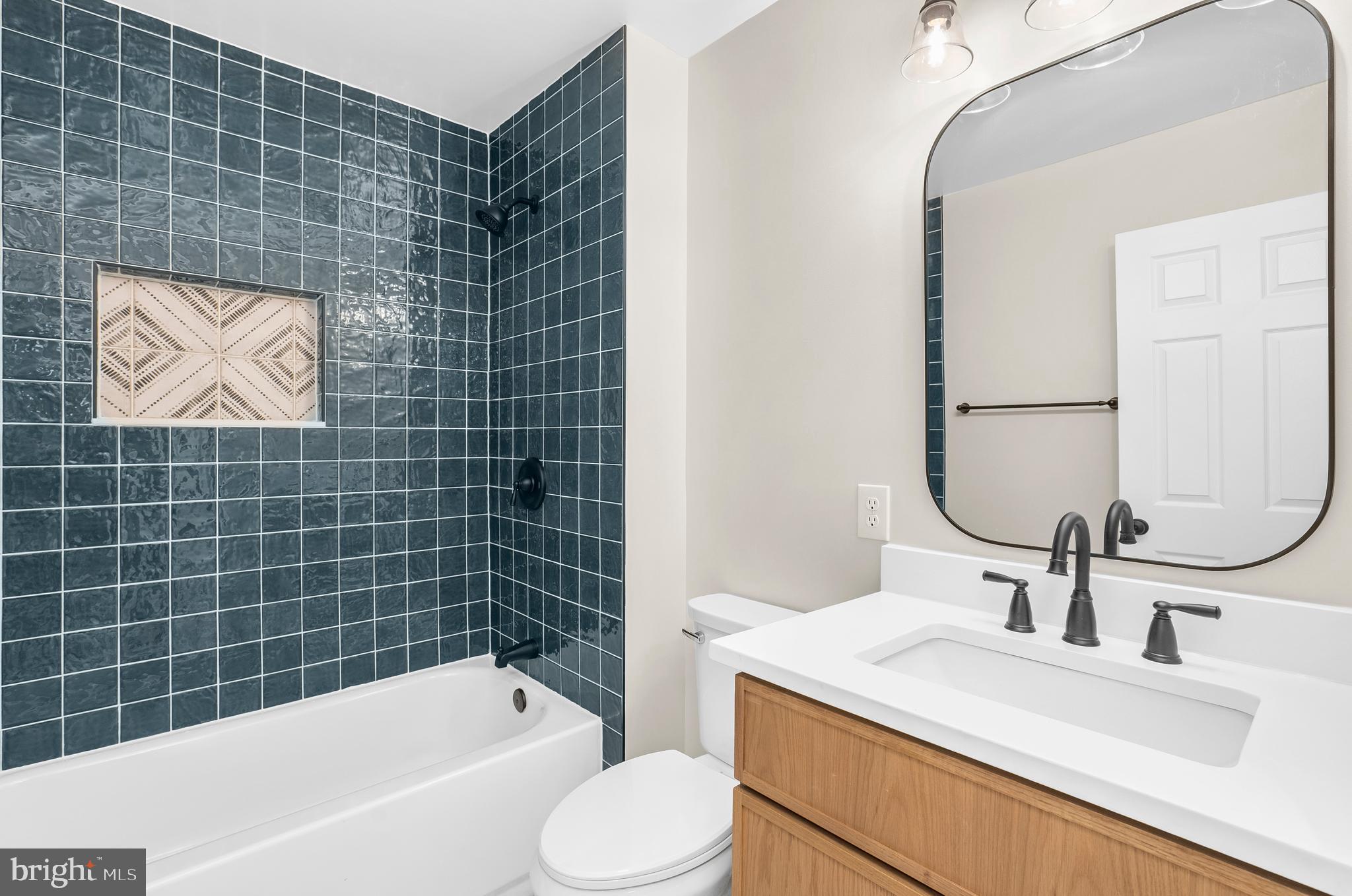 5485 Solomons Island Road Lothian, MD 20711 - Photo 54 of 64 a bathroom with a sink toilet and shower