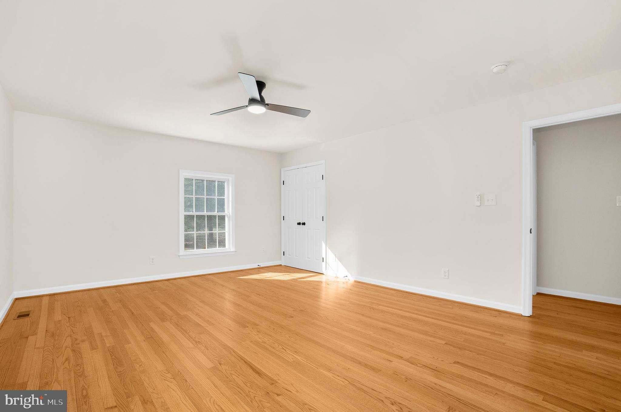 5485 Solomons Island Road Lothian, MD 20711 - Photo 64 of 64 a view of an empty room with wooden floor and a window