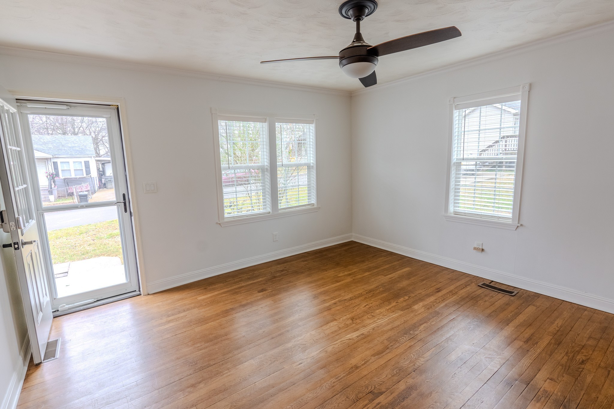 1899 Cherry Street Columbia, TN 38401 - Photo 6 of 19 a view of an empty room with wooden floor and a window