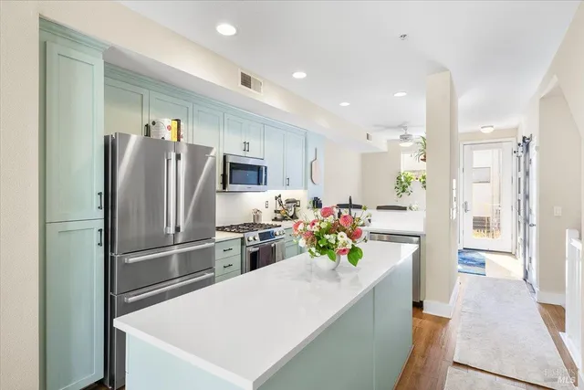 a kitchen with stainless steel appliances a refrigerator sink and stove